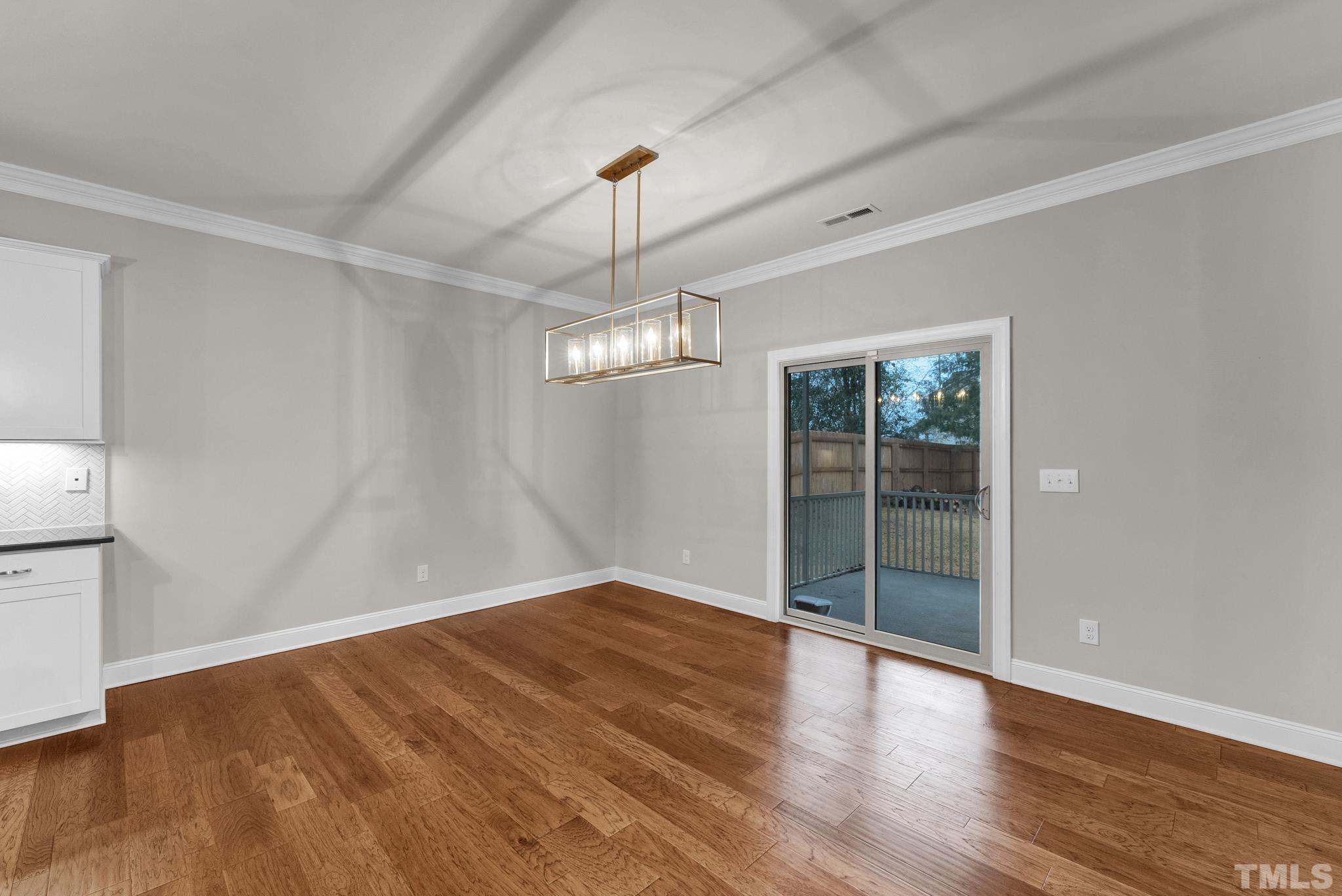 928 Barringer Drive Raleigh, NC 27606 - Photo 8 of 32 wooden floor in an empty room with a window