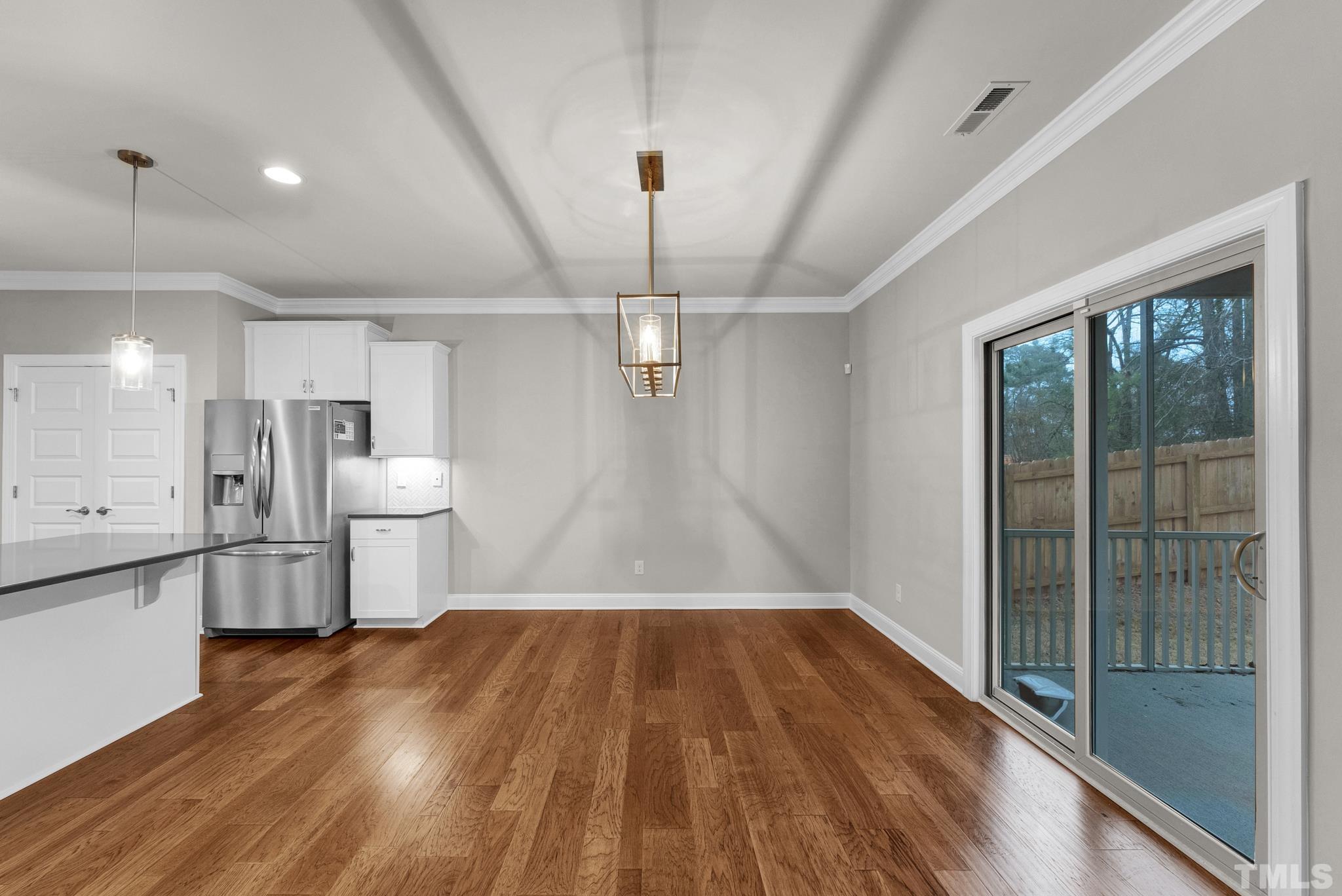 928 Barringer Drive Raleigh, NC 27606 - Photo 9 of 32 a view of a kitchen with wooden floor and electronic appliances