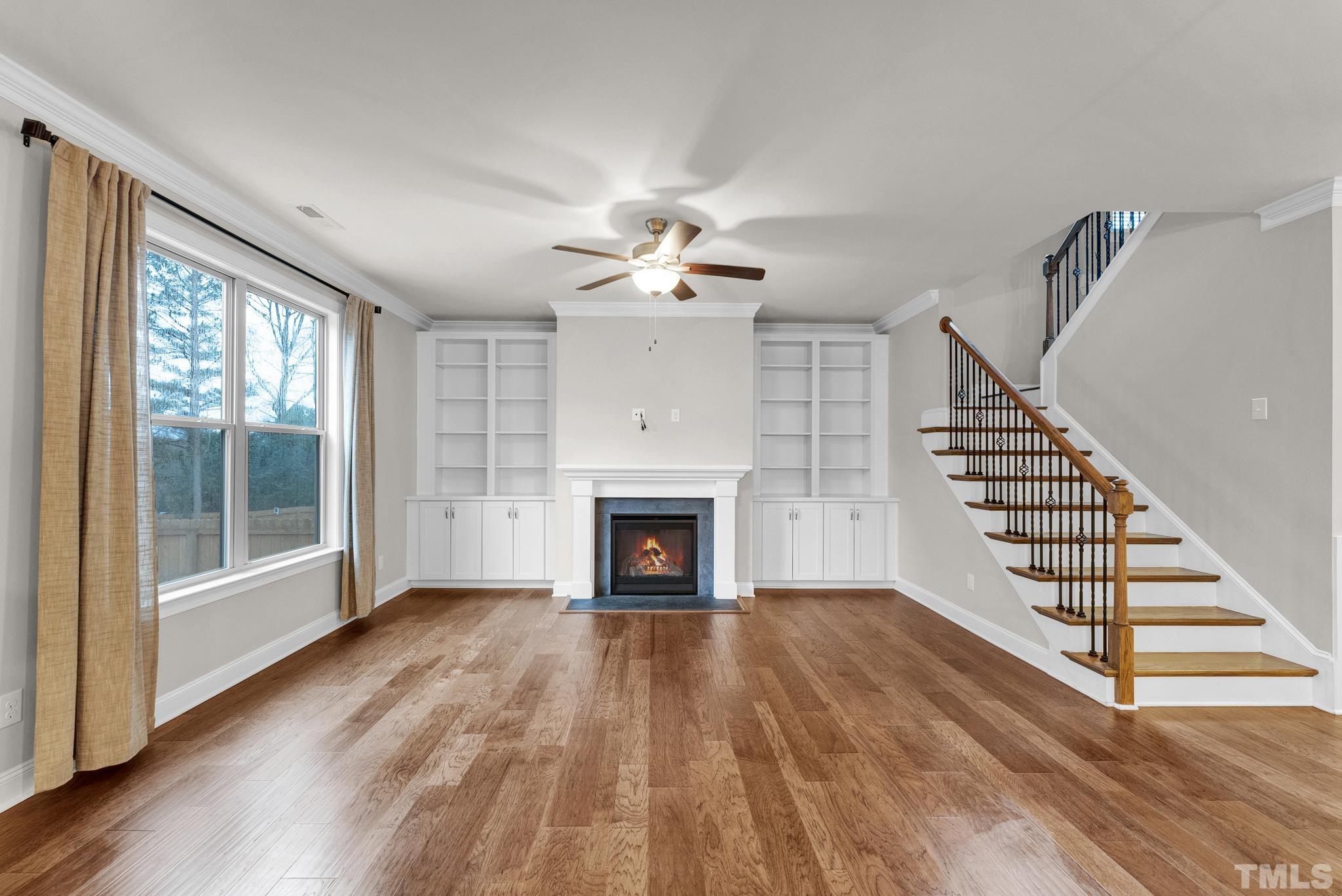 928 Barringer Drive Raleigh, NC 27606 - Photo 10 of 32 wooden floor fireplace and windows in an empty room