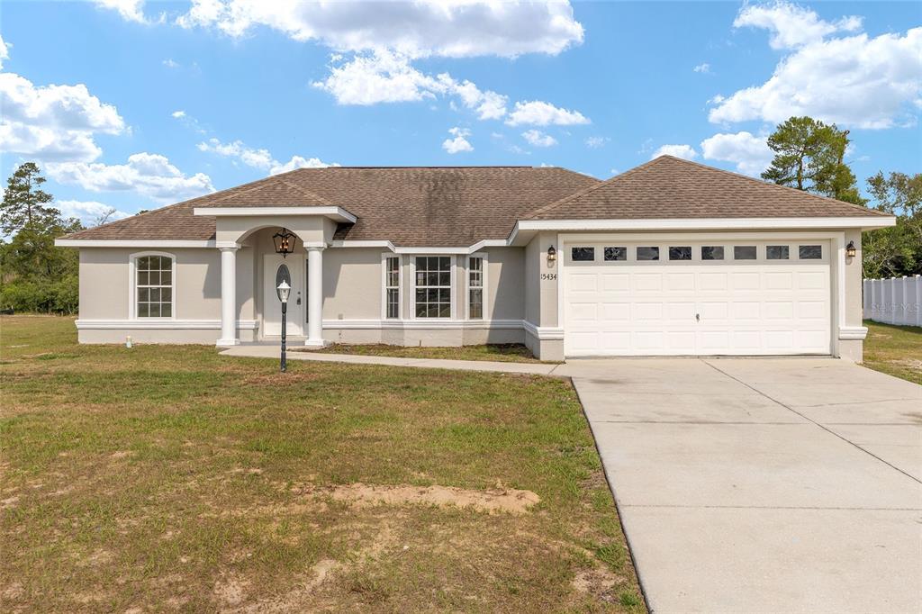 15434 Southwest 23rd Court Road Ocala, FL 34473 - Photo 1 of 41 a front view of a house with a yard