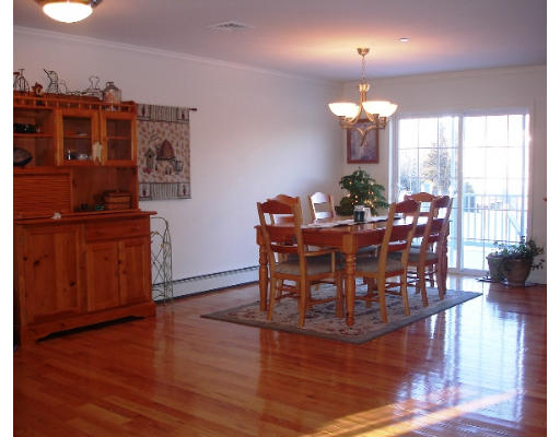 22 Scribner Road, Unit 81 Fremont, NH 03044 - Photo 1 of 10 a view of a dining room with furniture window and wooden floor