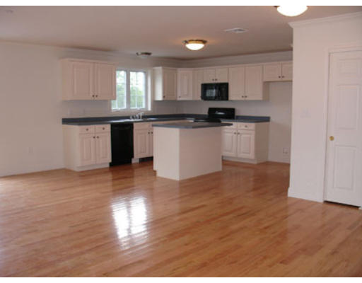 22 Scribner Road, Unit 81 Fremont, NH 03044 - Photo 7 of 10 a kitchen with granite countertop a stove top oven a sink a counter space and cabinets