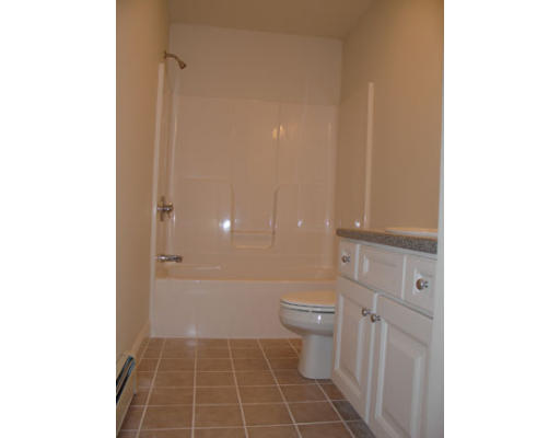 22 Scribner Road, Unit 81 Fremont, NH 03044 - Photo 8 of 10 a bathroom with a glass door shower