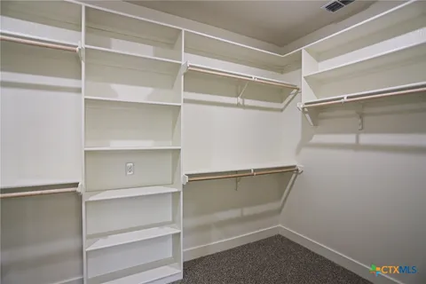 a view of an empty walk in closet