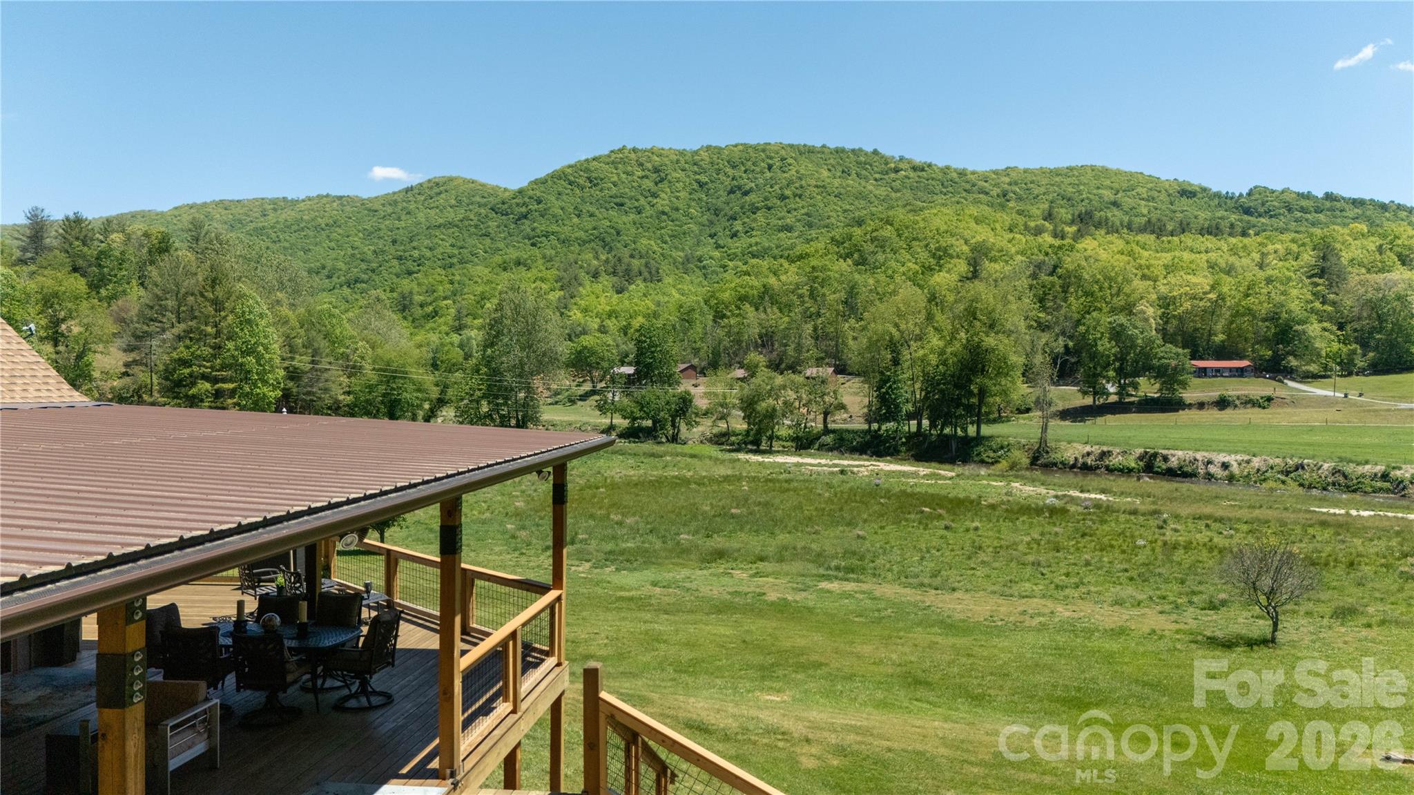 93 Franklin Crest Road Spruce Pine, NC 28777 - Photo 17 of 47 a view of a backyard with a mountain