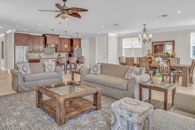 a dining room filled chandelier and kitchen view
