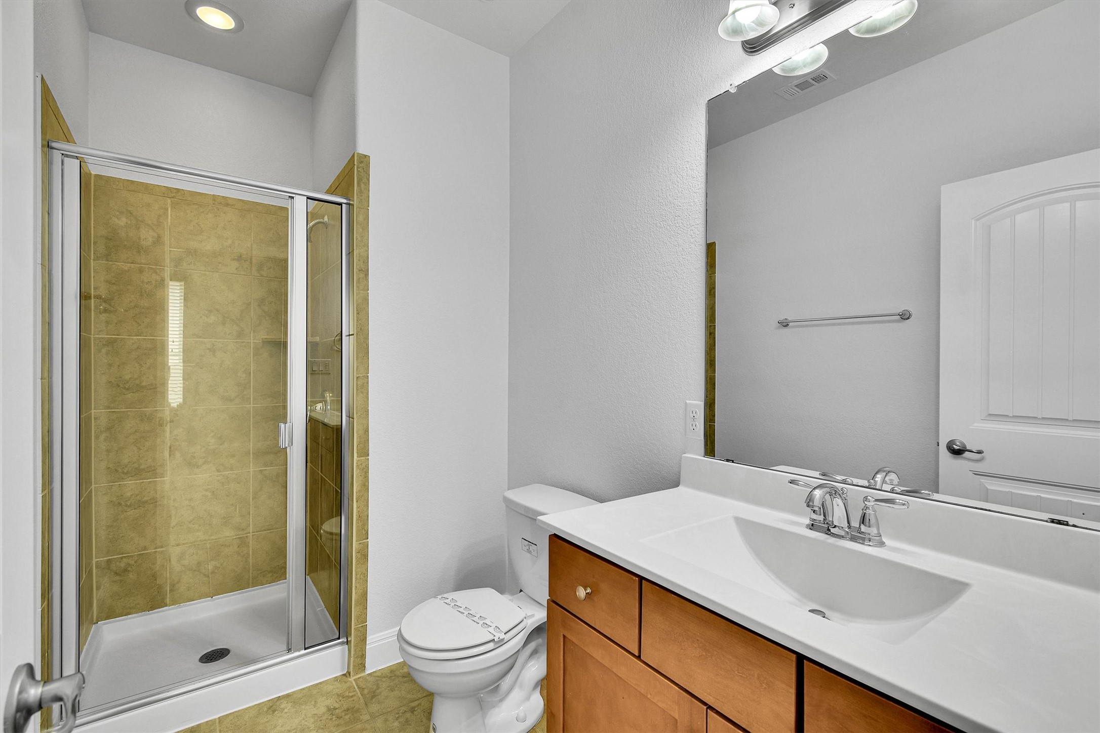 2325 Blended Tree Ranch Drive Leander, TX 78641 - Photo 32 of 35 A well-appointed bath features a spacious shower and a vanity with ample counter space.