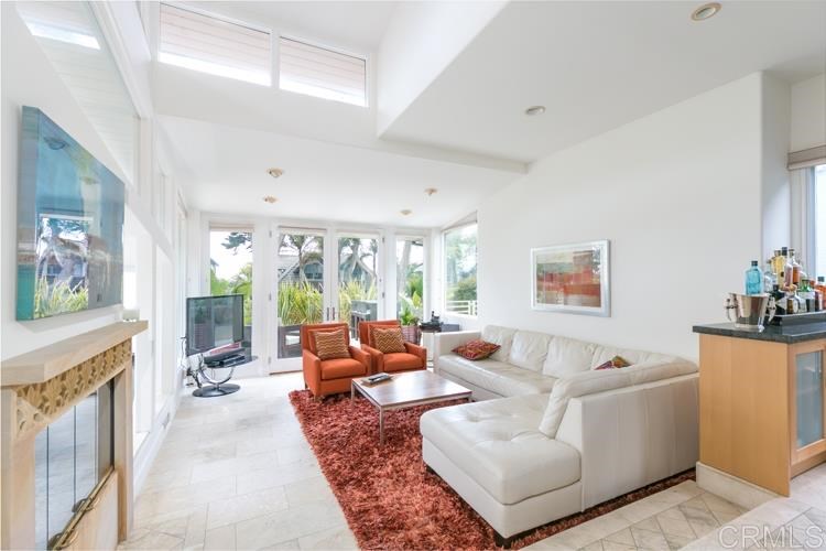 1407 Ocean Avenue Del Mar, CA 92014 - Photo 3 of 9 a living room with furniture large window and a fireplace
