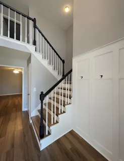 a view of a room with wooden floor