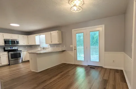 a view of an empty room and a sink