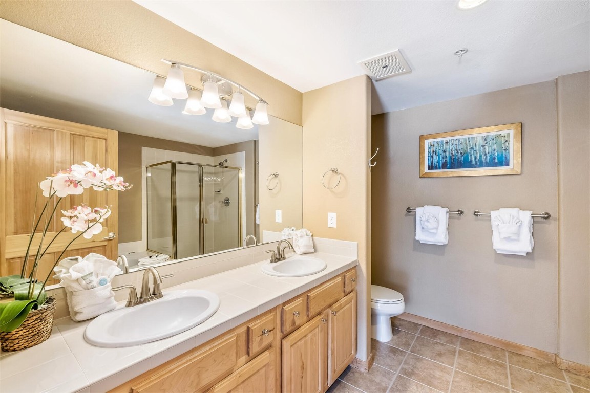 23110 Highway 6, Unit 5015 Keystone, CO 80435 - Photo 16 of 32 a bathroom with a granite countertop sink mirror vanity and toilet