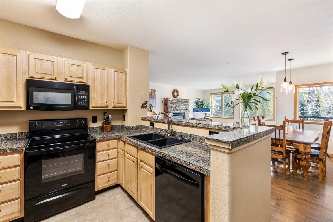 23110 Highway 6, Unit 5015 Keystone, CO 80435 - Photo 7 of 32 a kitchen with a sink stove and microwave