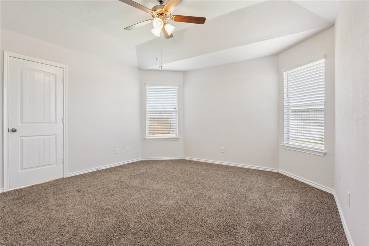 5830 Copano Road Belton, TX 76513 - Photo 19 of 34 Carpeted spare room with plenty of natural light, baseboards, and ceiling fan