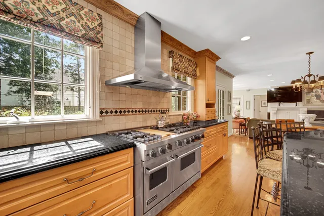 a kitchen with stainless steel appliances granite countertop a stove and a sink