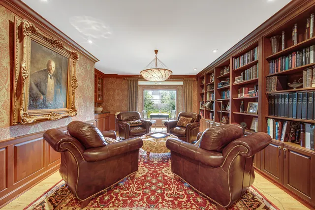 a living room with fireplace furniture and a book shelf