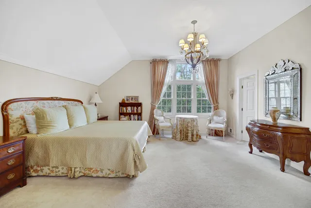 a bathroom with a sink double vanity granite tub shower and a mirror