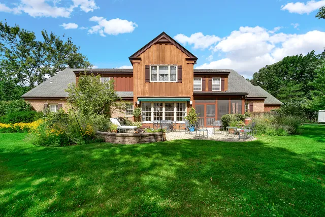 a front view of a house with a yard table and chairs