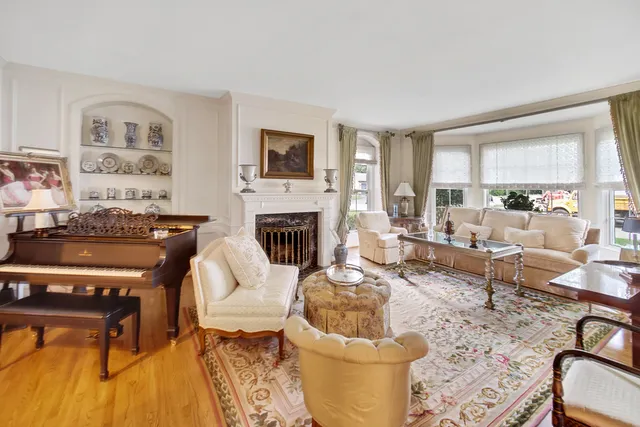 a living room with furniture fireplace and a table