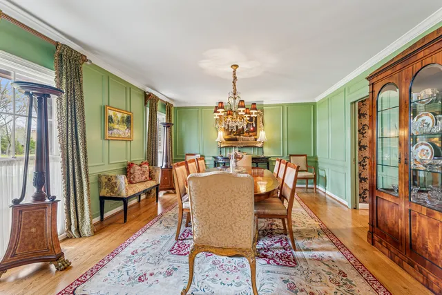 a dining room with furniture a rug and wooden floor