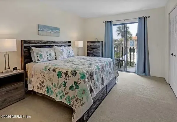 a bedroom with bed and a night stand