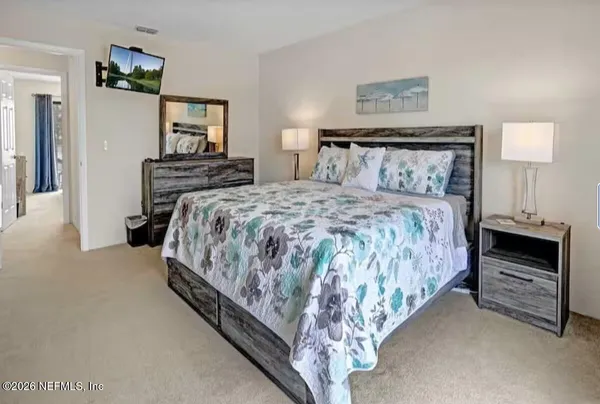 a bedroom with a bed and a television