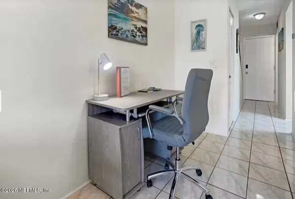 a bedroom with two beds and a large window