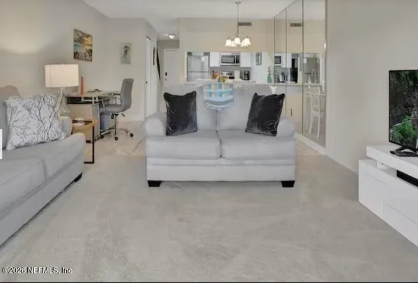 a view of living room with furniture and a flat screen tv