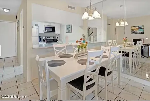 a bedroom with a bed lamp and a window