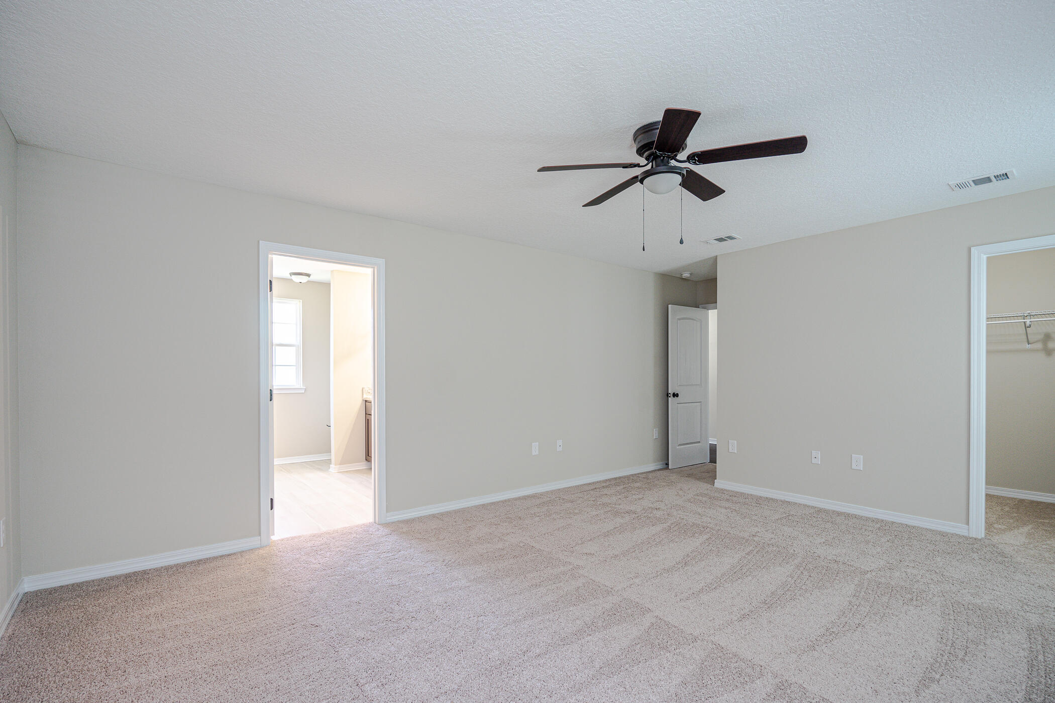 243 Wainwright Drive Crestview, FL 32539 - Photo 18 of 38 a view of a room with a ceiling fan and carpet