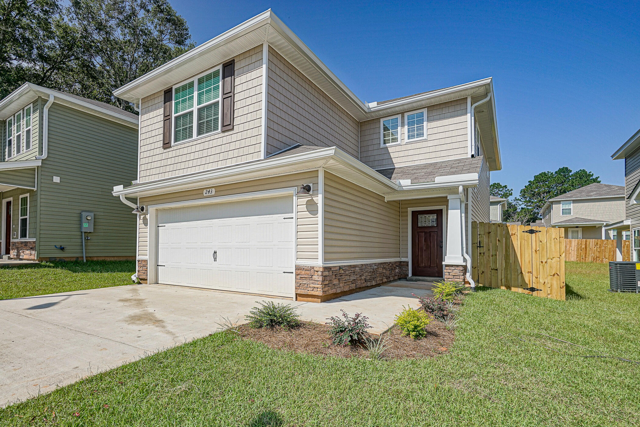 243 Wainwright Drive Crestview, FL 32539 - Photo 2 of 38 a front view of a house with a yard and garage