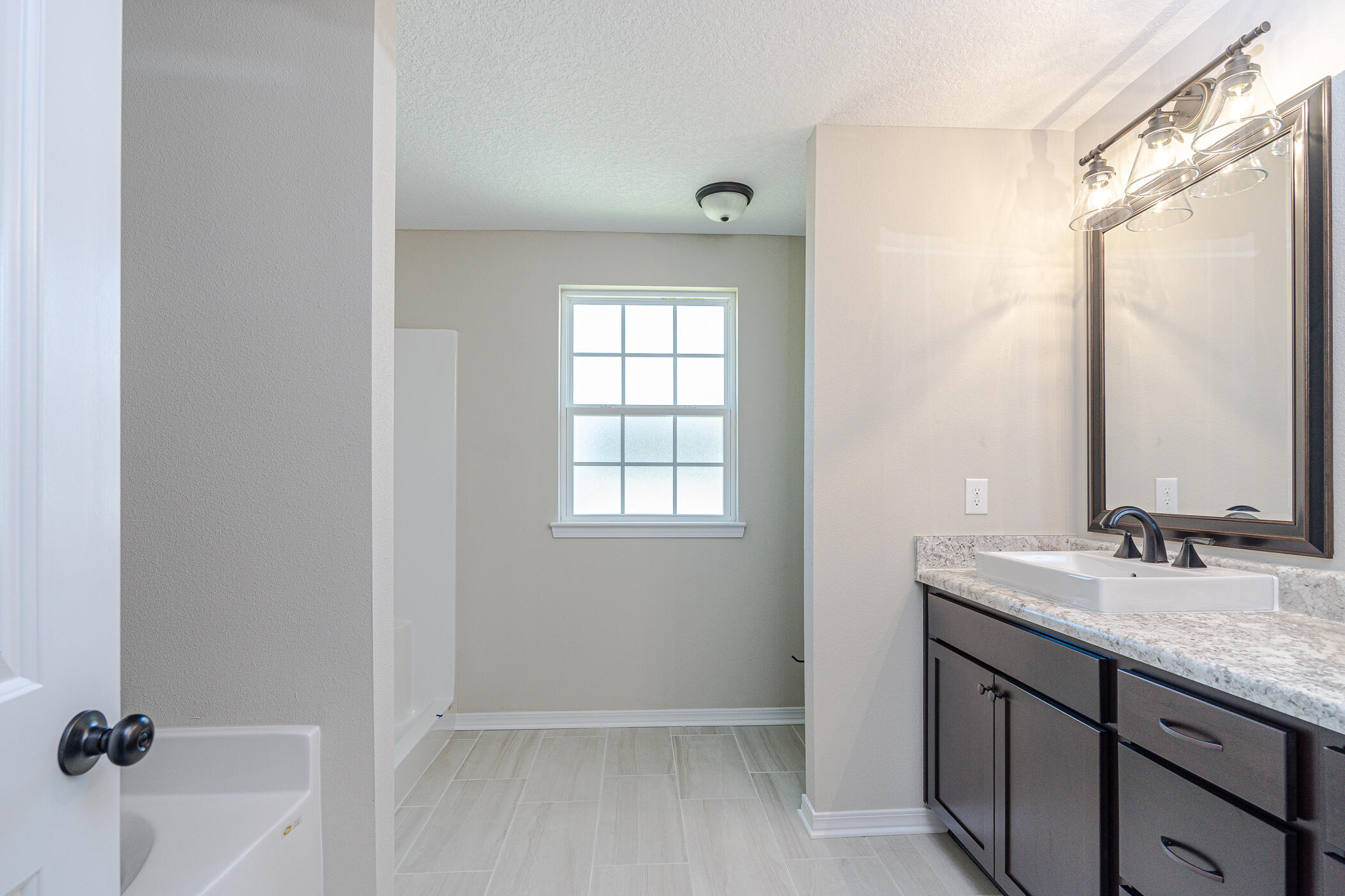 243 Wainwright Drive Crestview, FL 32539 - Photo 22 of 38 a bathroom with a granite countertop sink and a mirror