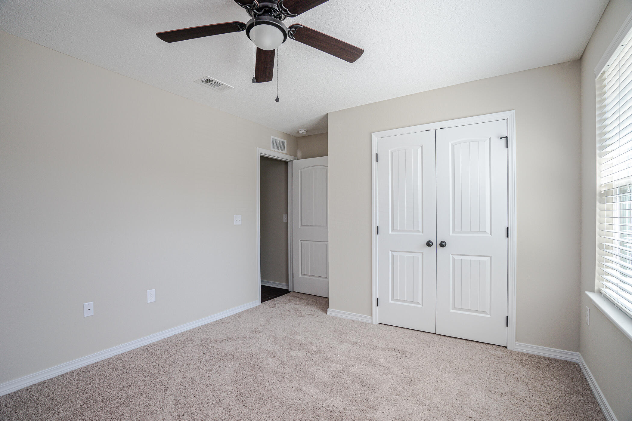 243 Wainwright Drive Crestview, FL 32539 - Photo 29 of 38 an empty room with a ceiling fan and window