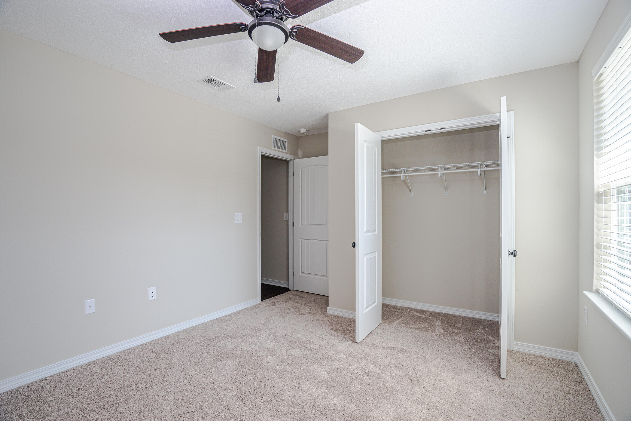 243 Wainwright Drive Crestview, FL 32539 - Photo 30 of 38 an empty room with closet and windows