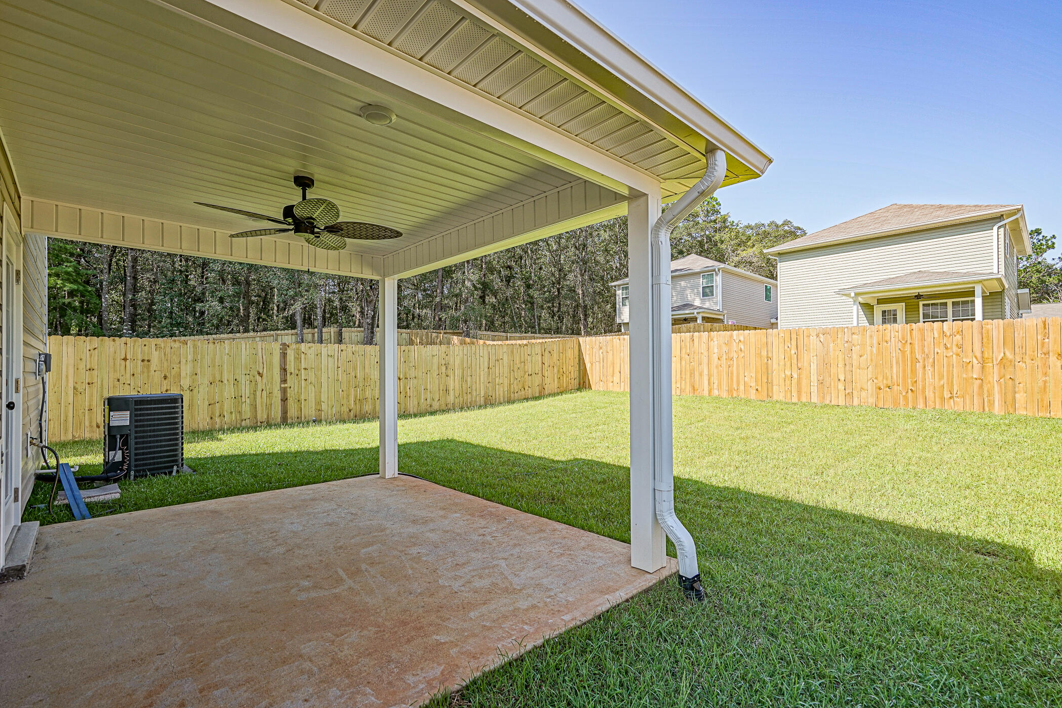 243 Wainwright Drive Crestview, FL 32539 - Photo 4 of 38 a view of a backyard with table and chairs under an umbrella
