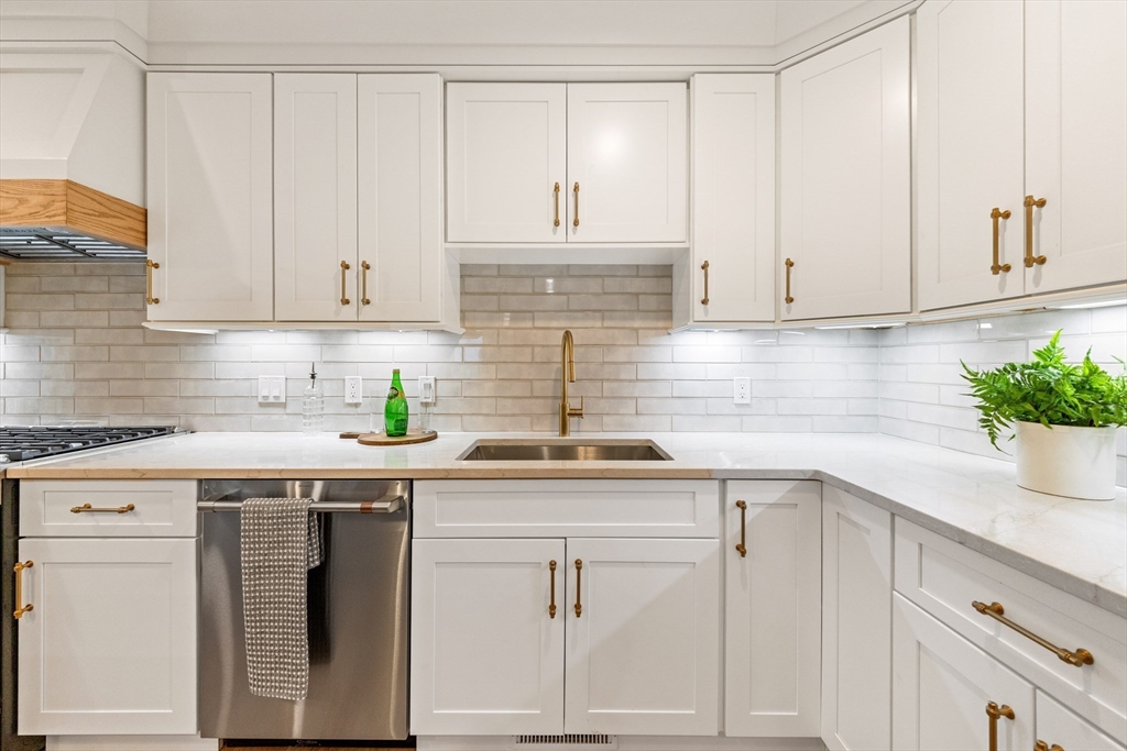 110 Wilson Road Bedford, MA 01730 - Photo 11 of 37 a kitchen with white cabinets and white appliances
