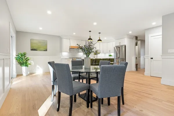 a view of a dining room with furniture and wooden floor