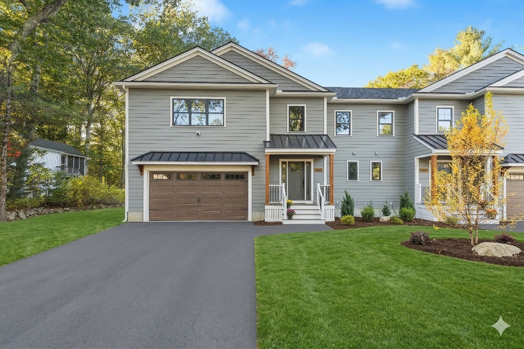 110 Wilson Road Bedford, MA 01730 - Photo 2 of 37 a front view of a house with a yard and garage
