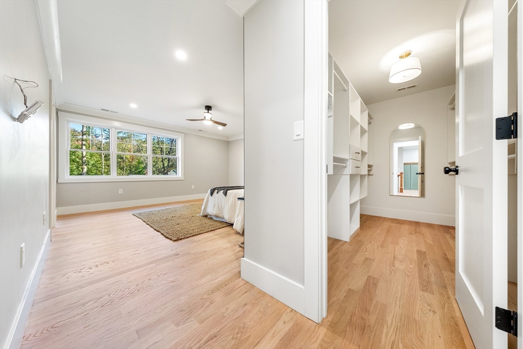110 Wilson Road Bedford, MA 01730 - Photo 21 of 37 a view of a hallway with wooden floor and a bathroom