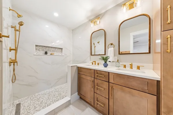 a bathroom with a double vanity sink mirror and