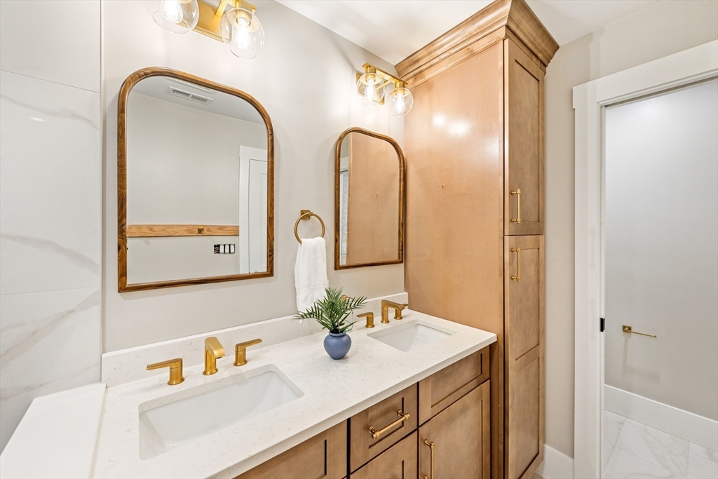 110 Wilson Road Bedford, MA 01730 - Photo 25 of 37 a bathroom with a sink and a mirror
