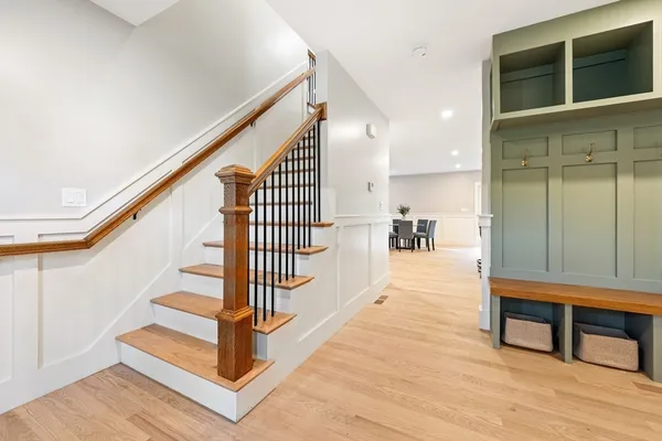 a view of entryway and hall with wooden floor