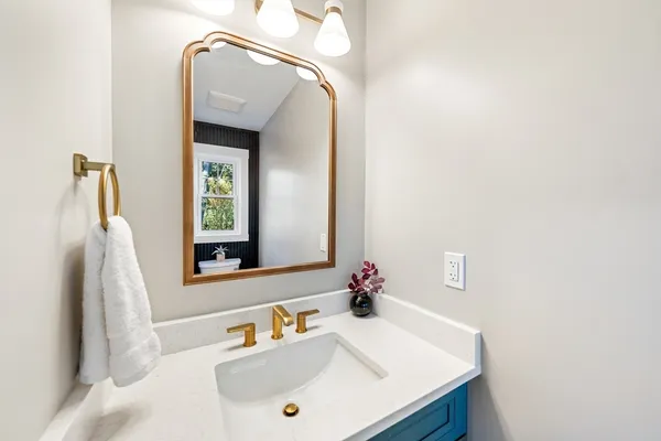 a bathroom with a sink vanity and a mirror