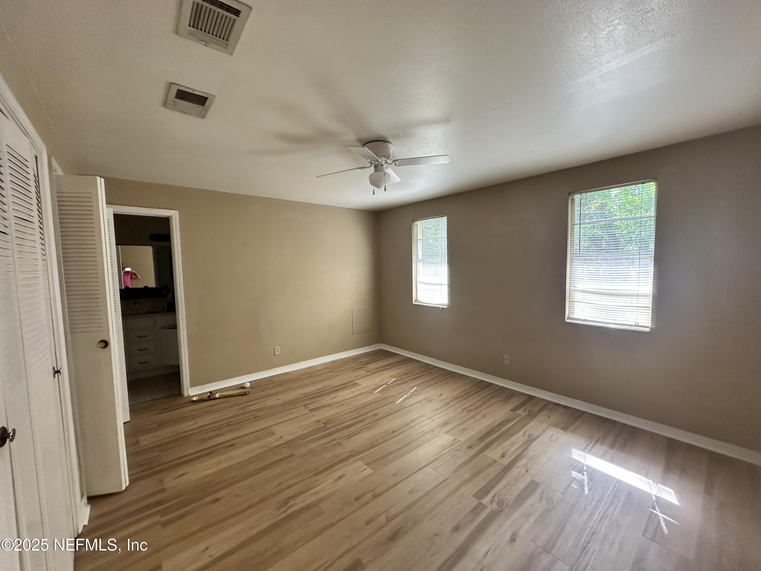 1644 El Camino Road, Unit 5 Jacksonville, FL 32216 - Photo 12 of 15 wooden floor in an empty room with a window