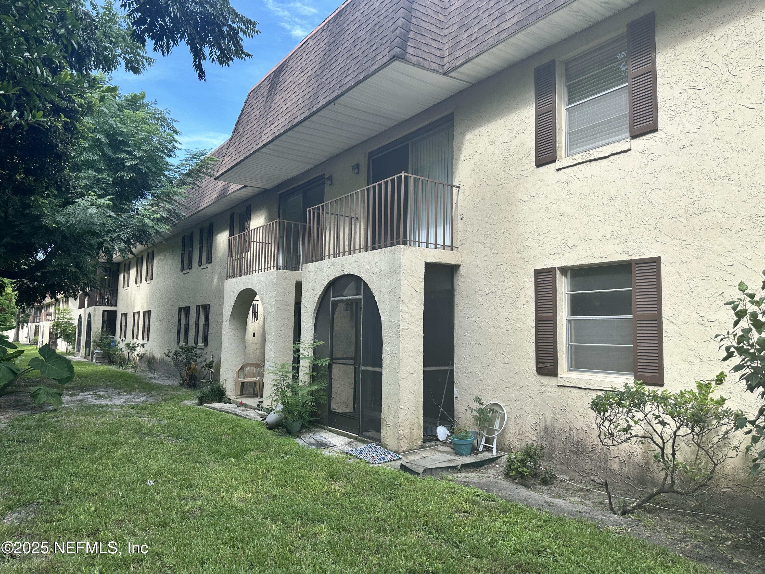 1644 El Camino Road, Unit 5 Jacksonville, FL 32216 - Photo 13 of 15 a front view of a house with garden