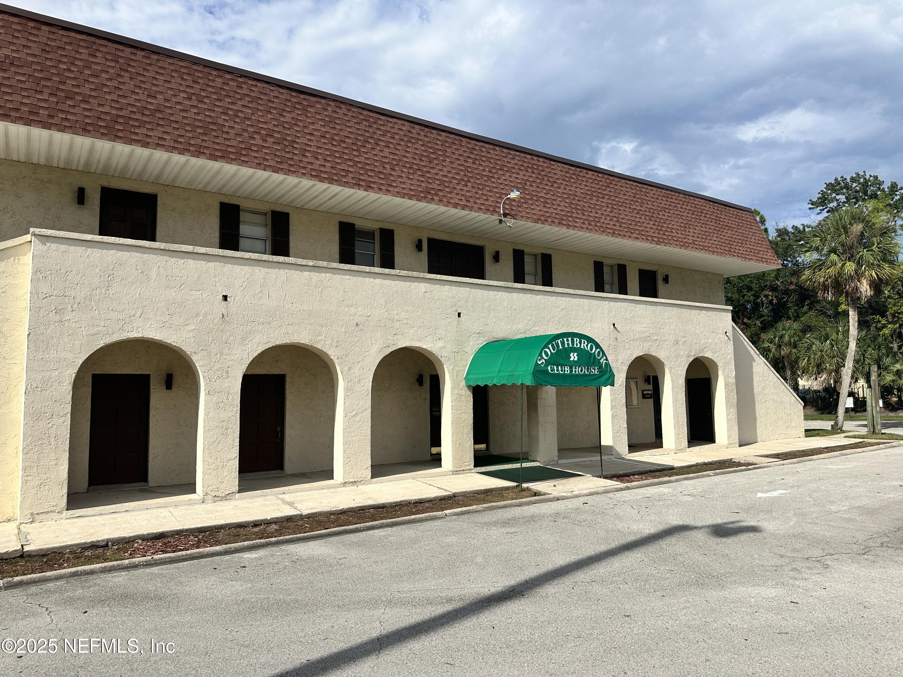 1644 El Camino Road, Unit 5 Jacksonville, FL 32216 - Photo 15 of 15 a view of a white house with a outdoor space
