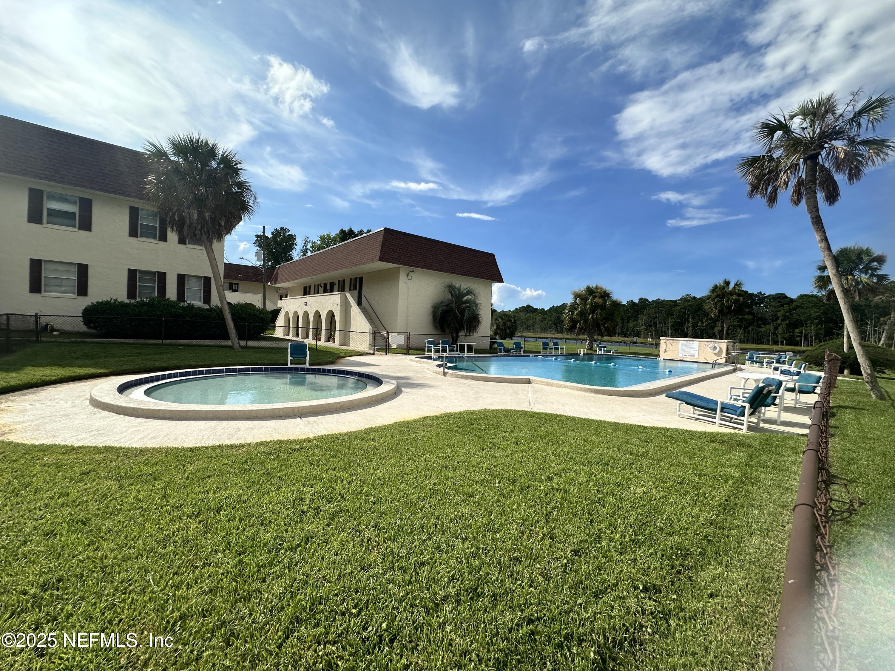 1644 El Camino Road, Unit 5 Jacksonville, FL 32216 - Photo 3 of 15 a view of a house with swimming pool and a yard