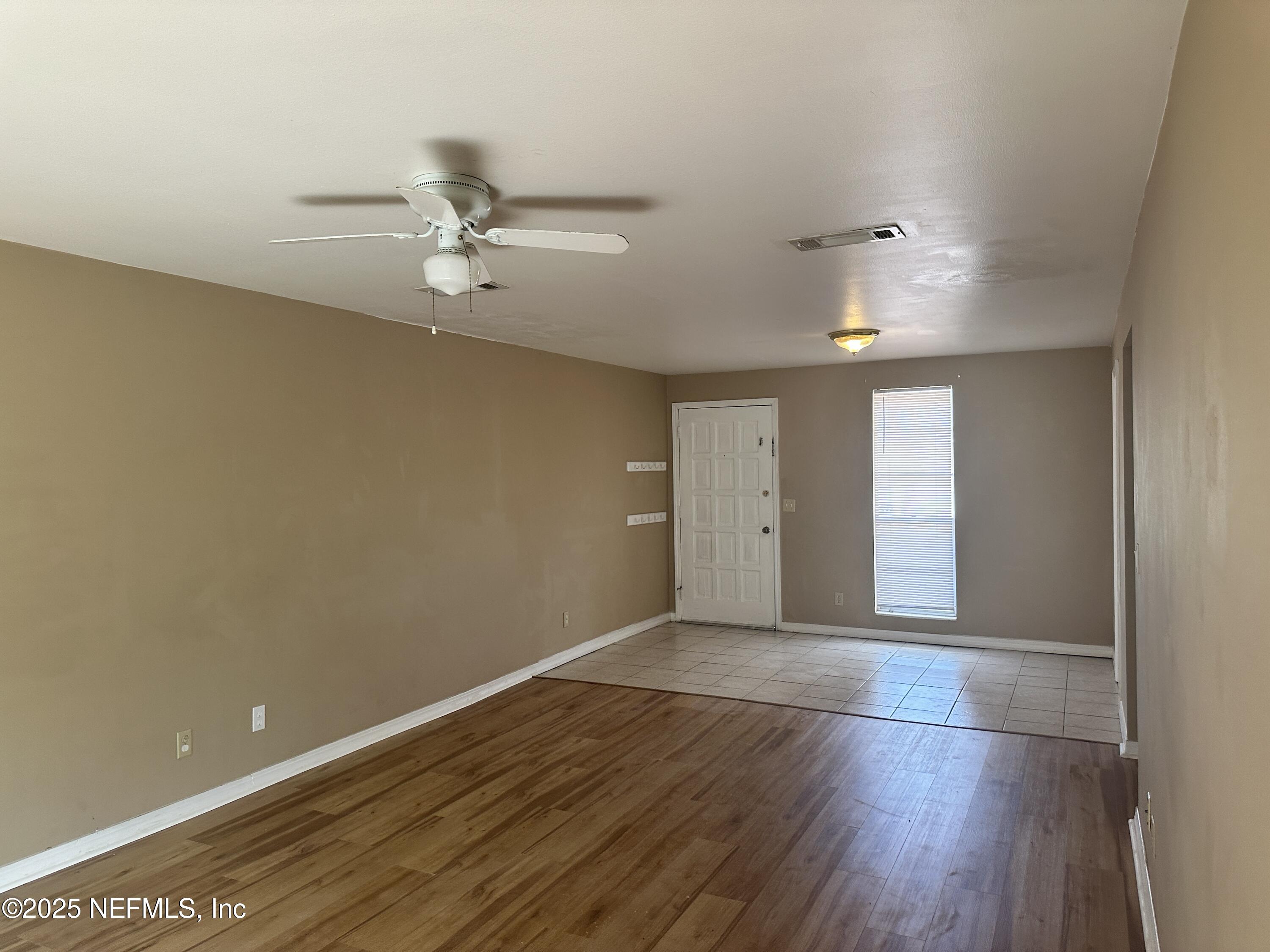 1644 El Camino Road, Unit 5 Jacksonville, FL 32216 - Photo 6 of 15 an empty room with wooden floor and windows