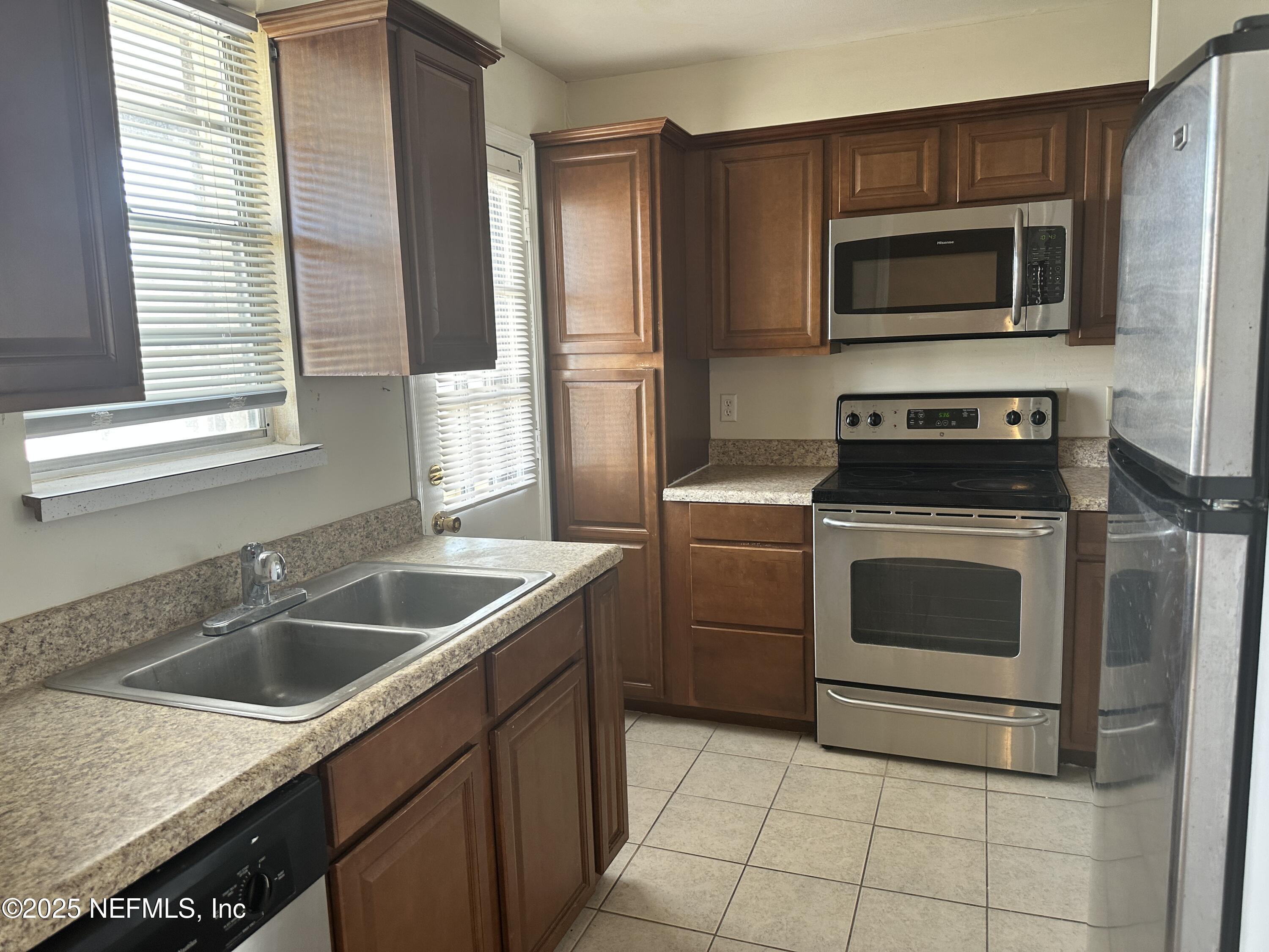1644 El Camino Road, Unit 5 Jacksonville, FL 32216 - Photo 7 of 15 a kitchen with a sink stove and microwave