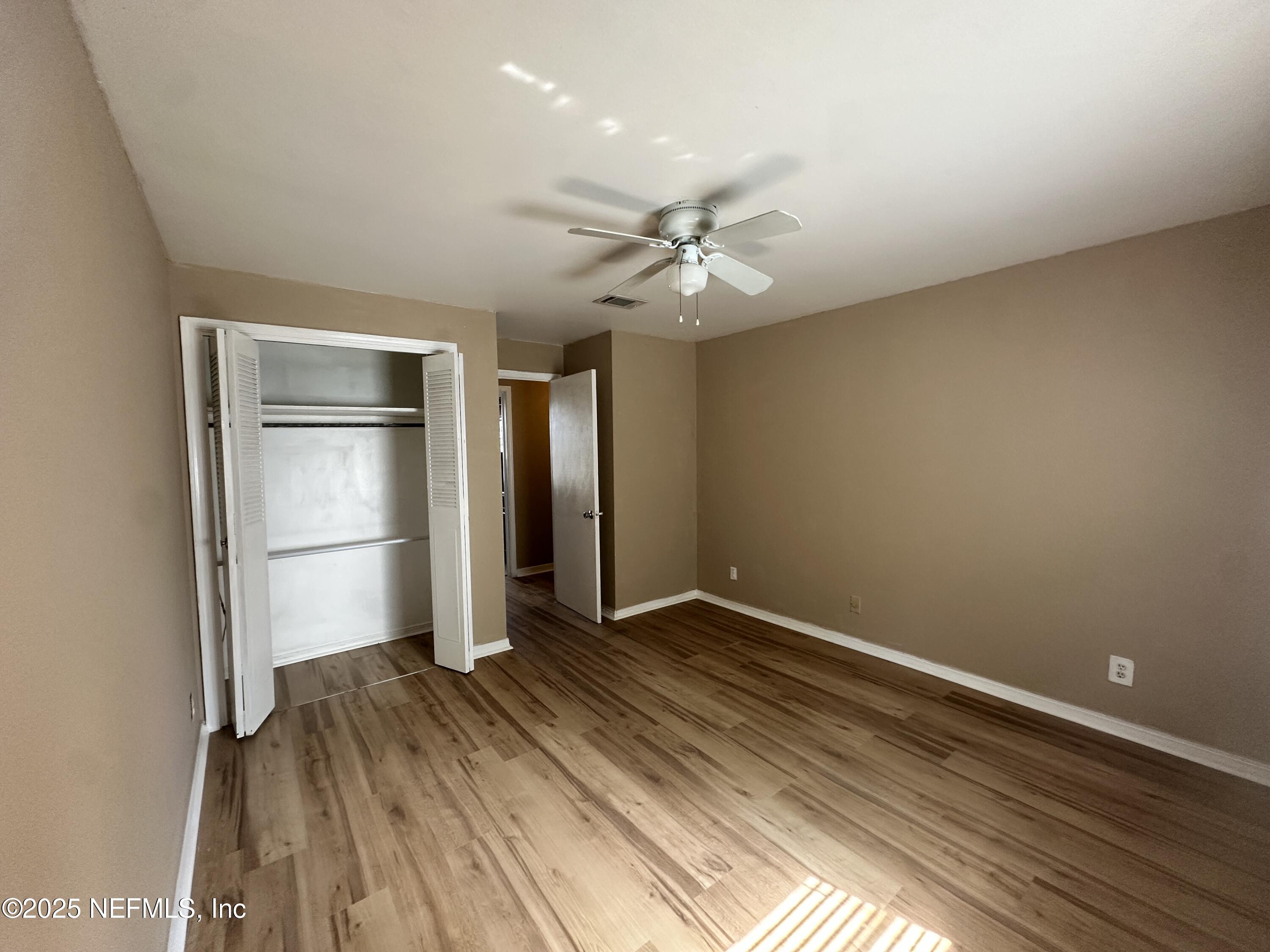 1644 El Camino Road, Unit 5 Jacksonville, FL 32216 - Photo 9 of 15 wooden floor in an empty room with a window