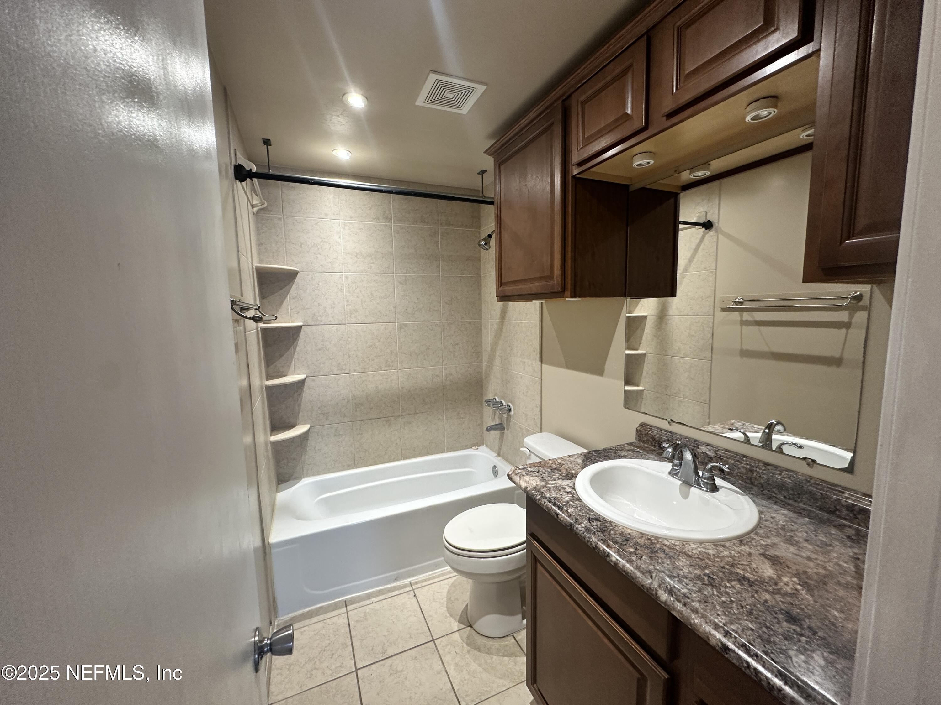 1644 El Camino Road, Unit 5 Jacksonville, FL 32216 - Photo 10 of 15 a bathroom with a granite countertop sink toilet and shower